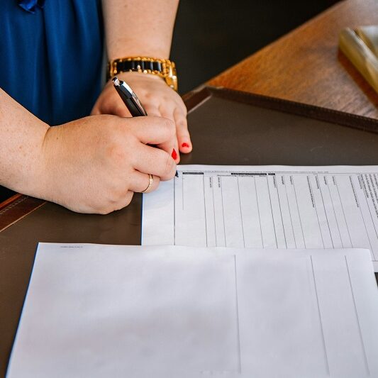 female signing paperwork